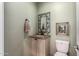 Charming powder room features decorative mirror and traditional-style vanity with granite countertop at 5234 E Carol Ave, Mesa, AZ 85206
