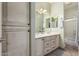 Bathroom featuring dual sinks, quartz counters, and an enclosed shower and tub at 5234 E Carol Ave, Mesa, AZ 85206