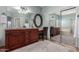 Bright main bathroom boasts a dual vanity, soaking tub, and seamless glass shower at 5234 E Carol Ave, Mesa, AZ 85206
