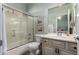 Bright bathroom with shower over tub, single vanity, and a mirror at 5234 E Carol Ave, Mesa, AZ 85206