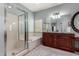 Stylish bathroom showcasing dual vanity, soaking tub, and walk-in shower with glass surround at 5234 E Carol Ave, Mesa, AZ 85206