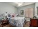 Charming bedroom featuring natural light, a ceiling fan, and carpet flooring at 5234 E Carol Ave, Mesa, AZ 85206