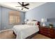 Cozy bedroom featuring soft, natural light through wood shutters and a ceiling fan at 5234 E Carol Ave, Mesa, AZ 85206
