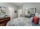Well-lit bedroom with connecting bathroom, carpet flooring, and a mirrored closet at 5234 E Carol Ave, Mesa, AZ 85206