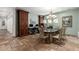 The dining room features custom wooden cabinets, travertine floors, and a decorative chandelier at 5234 E Carol Ave, Mesa, AZ 85206
