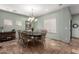Light-filled dining room featuring a large table, chandelier, and tiled flooring at 5234 E Carol Ave, Mesa, AZ 85206