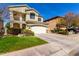 Charming two-story home with a well-manicured front lawn, driveway, two-car garage and tiled roof at 5234 E Carol Ave, Mesa, AZ 85206