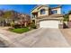Charming two-story home with a well-manicured front lawn, driveway, two-car garage and tiled roof at 5234 E Carol Ave, Mesa, AZ 85206