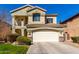 Charming two-story home with a well-manicured front lawn and a two-car garage and tiled roof at 5234 E Carol Ave, Mesa, AZ 85206
