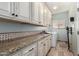 Laundry room with granite countertops and a convenient washing machine at 5234 E Carol Ave, Mesa, AZ 85206