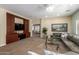 Open living area with a built-in media center, carpet flooring, and comfortable seating at 5234 E Carol Ave, Mesa, AZ 85206