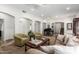 Open-concept living room featuring carpet floors, neutral tones, and an arched doorway at 5234 E Carol Ave, Mesa, AZ 85206