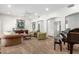 Spacious living room with a carpet floor, grand piano, neutral walls, and an arched doorway at 5234 E Carol Ave, Mesa, AZ 85206