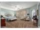 Tranquil main bedroom with sitting area, neutral carpet, and serene color palette at 5234 E Carol Ave, Mesa, AZ 85206