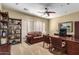 Home office featuring bookshelves, a ceiling fan, and a comfortable sitting area at 5234 E Carol Ave, Mesa, AZ 85206