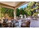 Covered outdoor patio with comfortable seating, outdoor kitchen, and lush greenery creating a private oasis at 5234 E Carol Ave, Mesa, AZ 85206