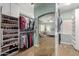 Well-organized walk-in closet with custom shelving and a mirror reflecting the main bedroom at 5234 E Carol Ave, Mesa, AZ 85206
