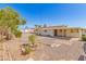 Gravel backyard featuring a mature trees, partial landscaping, and a stone paver patio area at 5732 E Covina Rd, Mesa, AZ 85205