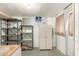 Unfinished basement space with shelving, storage closet, and a utility door with some water stains on the floor at 5732 E Covina Rd, Mesa, AZ 85205