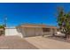 View of a single-story house showing the side garage, driveway, and desert landscaping at 5732 E Covina Rd, Mesa, AZ 85205