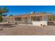 This single-story home features desert landscaping with a clean white exterior and warm brown roof at 5732 E Covina Rd, Mesa, AZ 85205