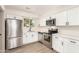Updated kitchen with stainless steel appliances, white cabinets, and light countertops at 5732 E Covina Rd, Mesa, AZ 85205