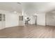 Open-concept living room with new flooring, light walls, and access to kitchen at 5732 E Covina Rd, Mesa, AZ 85205