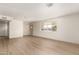 This living room is ready for your personal touch with light walls, new flooring, and modern fixtures at 5732 E Covina Rd, Mesa, AZ 85205