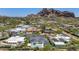 Expansive aerial view of a stylish home with a pool, set against a mountainous backdrop at 5812 N 44Th Pl, Phoenix, AZ 85018