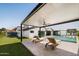A backyard featuring a pool, manicured lawn, lounge chairs, and covered patio at 5812 N 44Th Pl, Phoenix, AZ 85018