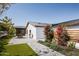 A backyard featuring a patio, manicured lawn, flowering plants, and outdoor dining area at 5812 N 44Th Pl, Phoenix, AZ 85018