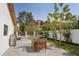 A backyard featuring a patio, manicured lawn, flowering plants, outdoor dining area and mountain views at 5812 N 44Th Pl, Phoenix, AZ 85018