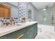 Beautiful bathroom with vibrant wallpaper, stylish mirrors, and modern marble flooring at 5812 N 44Th Pl, Phoenix, AZ 85018