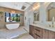 Modern bathroom featuring a soaking tub, gold hardware, and a sleek vanity at 5812 N 44Th Pl, Phoenix, AZ 85018