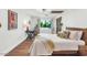 Light-filled bedroom featuring a wooden bedframe, desk, and a large window with outdoor views at 5812 N 44Th Pl, Phoenix, AZ 85018