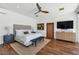 Modern bedroom featuring a king bed, ceiling fan, and dark hardwood floors at 5812 N 44Th Pl, Phoenix, AZ 85018