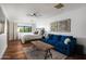 Bedroom features hardwood floors, a bed with a blue velvet sofa at the end, and a window with lots of light at 5812 N 44Th Pl, Phoenix, AZ 85018