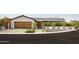 Well-manicured front yard featuring a modern exterior with wood garage door and desert landscaping at 5812 N 44Th Pl, Phoenix, AZ 85018