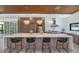 Modern kitchen island with seating, stylish lighting, and stainless steel appliances at 5812 N 44Th Pl, Phoenix, AZ 85018