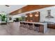 Modern kitchen with large island, bar seating, and views into dining and living spaces at 5812 N 44Th Pl, Phoenix, AZ 85018