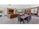 Open concept living and dining area features modern design with fireplace and pool view at 5812 N 44Th Pl, Phoenix, AZ 85018