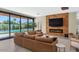 Living room featuring a fireplace, mounted TV, and glass doors leading to a pool at 5812 N 44Th Pl, Phoenix, AZ 85018