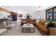 Spacious living room with a large sectional sofa, stylish decor, and views into the kitchen and dining areas at 5812 N 44Th Pl, Phoenix, AZ 85018