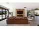 Bright living room features a modern fireplace, comfortable seating, and large windows overlooking the pool at 5812 N 44Th Pl, Phoenix, AZ 85018
