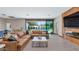 A living room with a large sectional couch and a view of the pool area at 5812 N 44Th Pl, Phoenix, AZ 85018