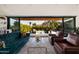 Elegant living room with views of the outdoor patio, stylish seating, and seamless indoor/outdoor living at 5812 N 44Th Pl, Phoenix, AZ 85018