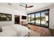 Bright main bedroom with a view of the pool, hardwood floors, and a spacious layout at 5812 N 44Th Pl, Phoenix, AZ 85018