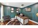 Sophisticated home office with dark green walls, hardwood floors, and stylish furnishings at 5812 N 44Th Pl, Phoenix, AZ 85018