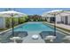 Inviting pool with built-in loungers and umbrellas, surrounded by manicured green turf at 5812 N 44Th Pl, Phoenix, AZ 85018