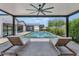 Under the covered patio, a tranquil pool with lounge chairs and a view of the modern home at 5812 N 44Th Pl, Phoenix, AZ 85018